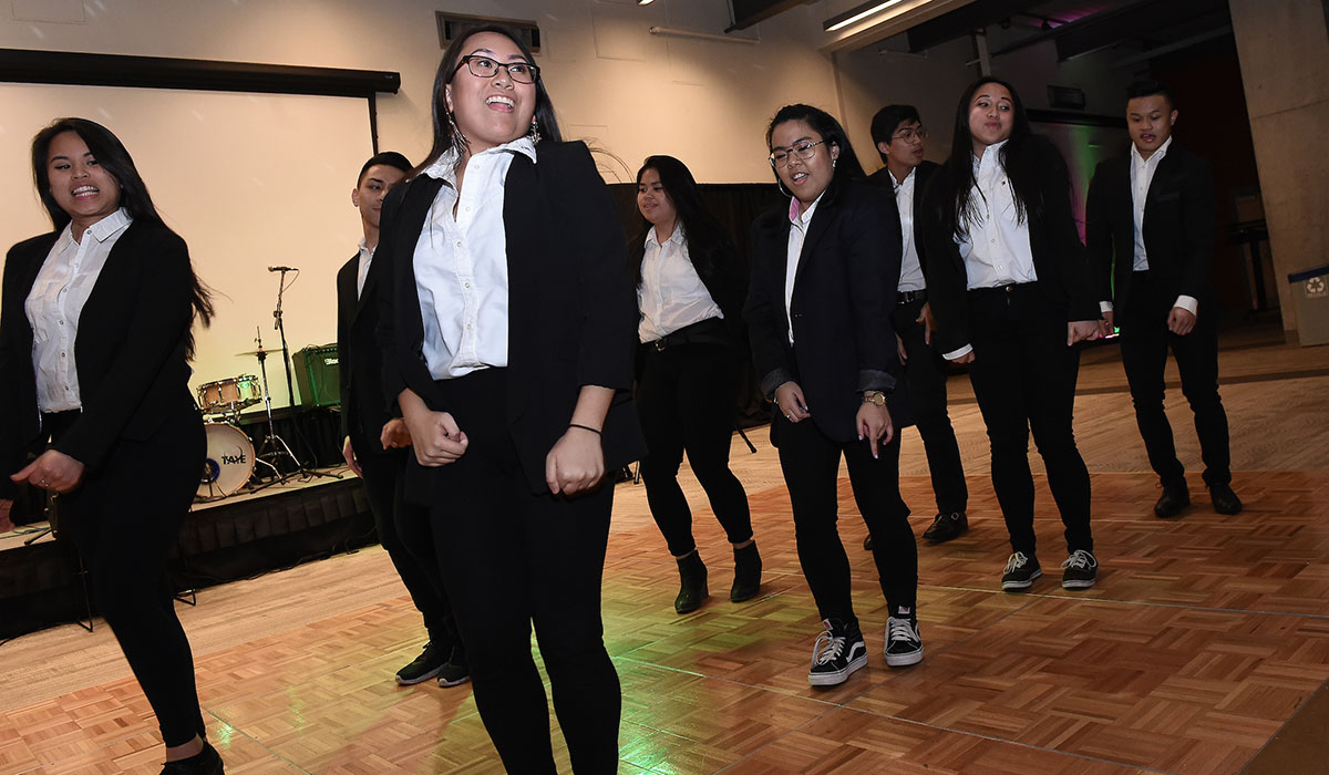 Catholic University students dancing at a student club event.